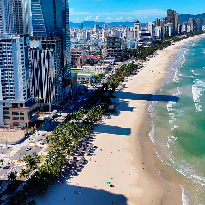 Aerial view of the Danang beachfront, with high-rise buildings along the shore and the South China Sea